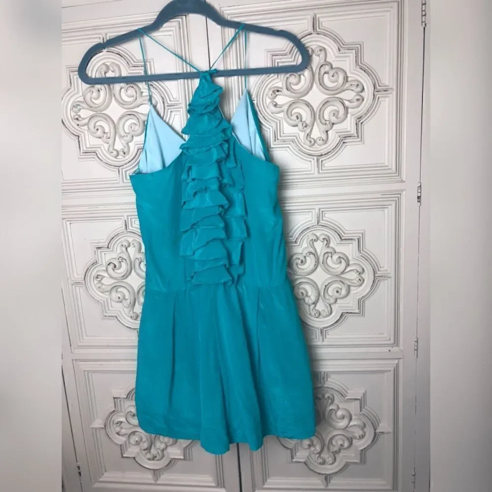 Turquoise wink romper with ruffle details size small